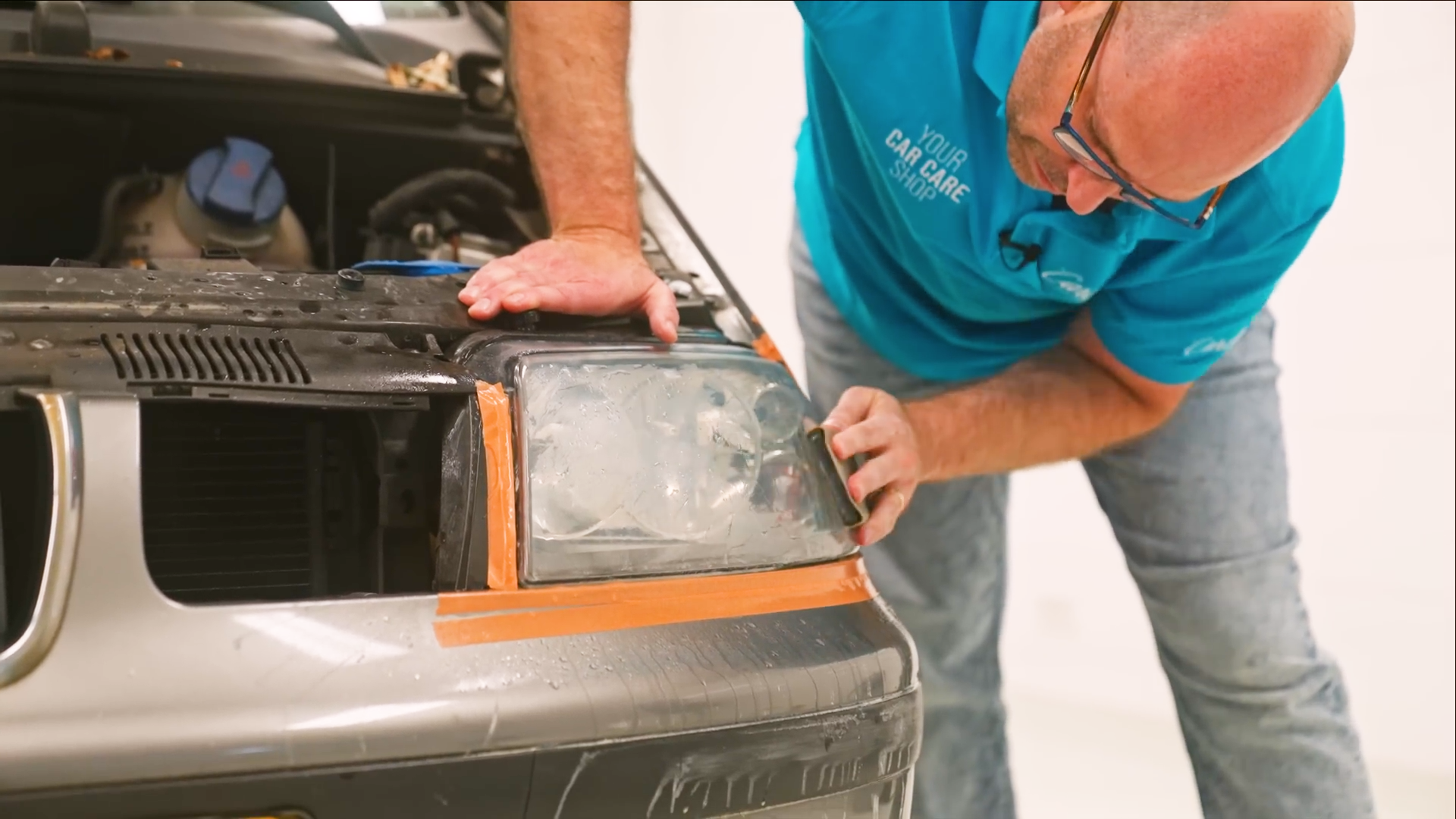 auto body repair, car headlight, headlight replacement, orange tape, mechanic